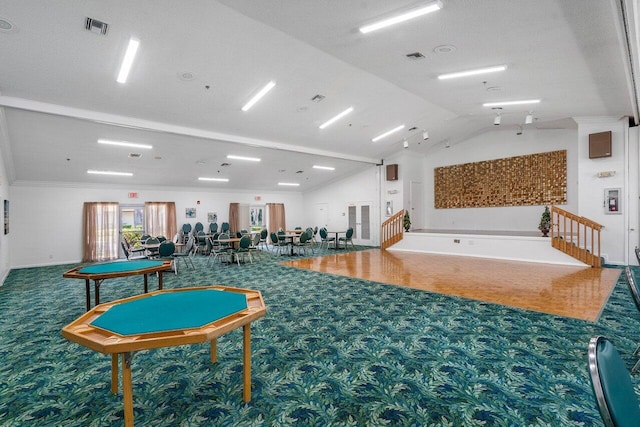 rec room featuring carpet, a textured ceiling, crown molding, and lofted ceiling