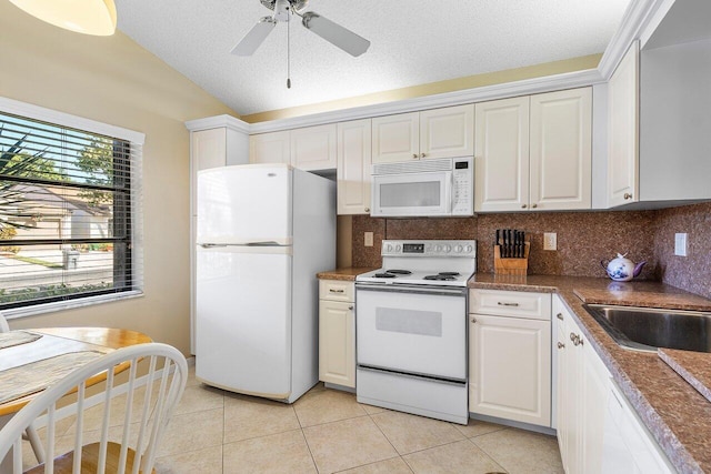 kitchen featuring white appliances and white cabinetry