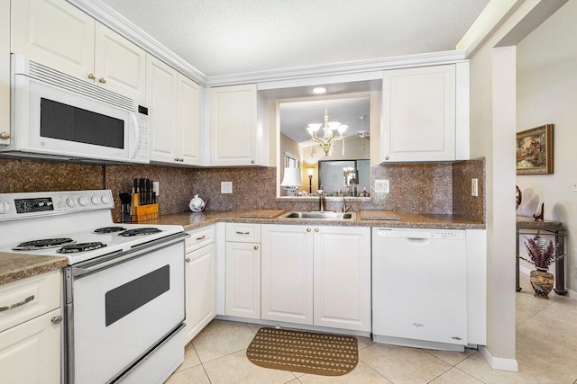 kitchen with a textured ceiling, white appliances, sink, a notable chandelier, and white cabinetry