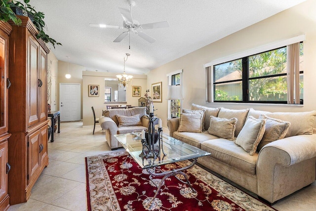 tiled living room with ceiling fan with notable chandelier, lofted ceiling, and a textured ceiling