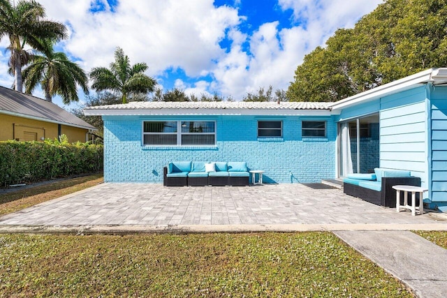 back of property featuring outdoor lounge area and a patio area