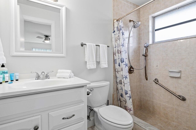 bathroom with a shower with curtain, ceiling fan, vanity, and toilet