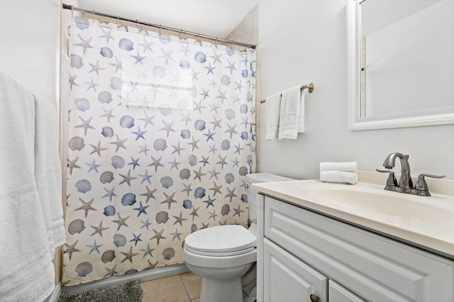 bathroom featuring tile patterned flooring, a shower with curtain, vanity, and toilet