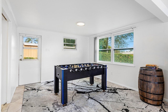 playroom with light tile patterned floors, ornamental molding, and a wealth of natural light