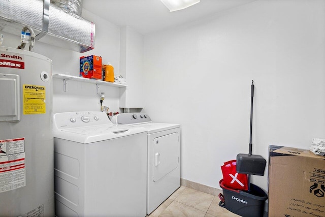 laundry area featuring washing machine and dryer, electric water heater, and light tile patterned floors