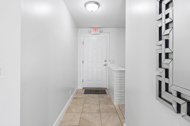 entryway with light tile patterned flooring