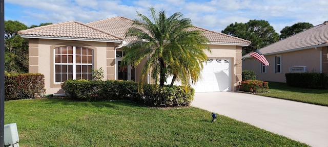 view of front of house with a garage, a tiled roof, a front lawn, and stucco siding