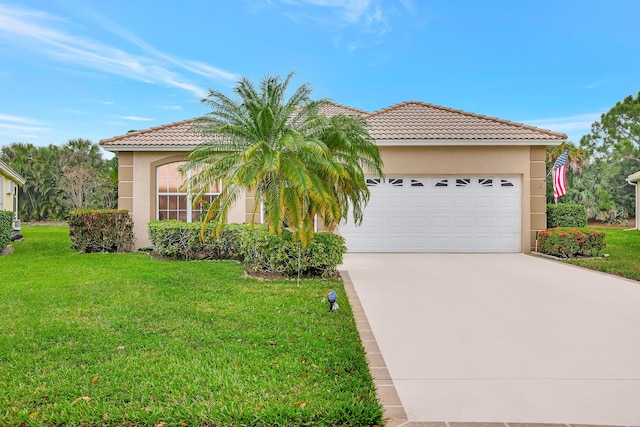 mediterranean / spanish home featuring a front yard and a garage