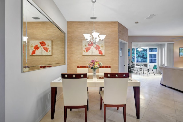 dining room with tile patterned floors and a chandelier