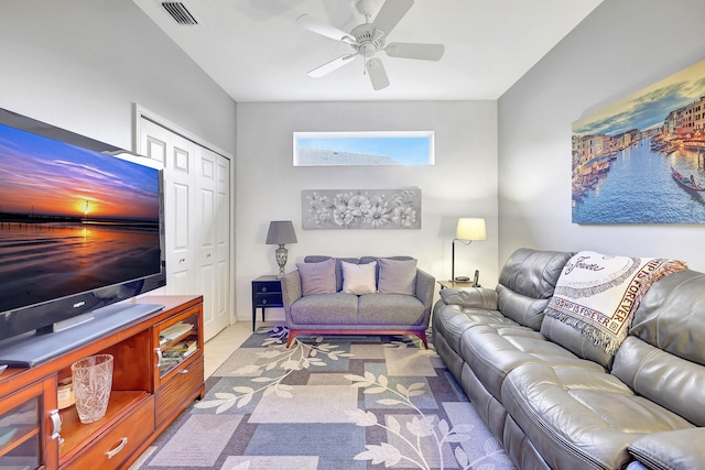 living room featuring ceiling fan, visible vents, and light colored carpet