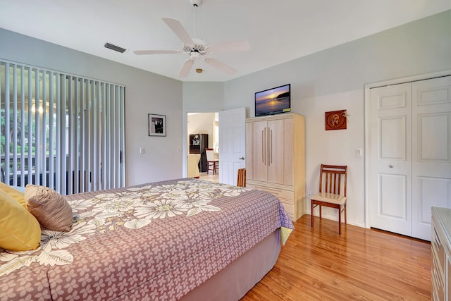 bedroom with light wood-type flooring, a closet, and ceiling fan