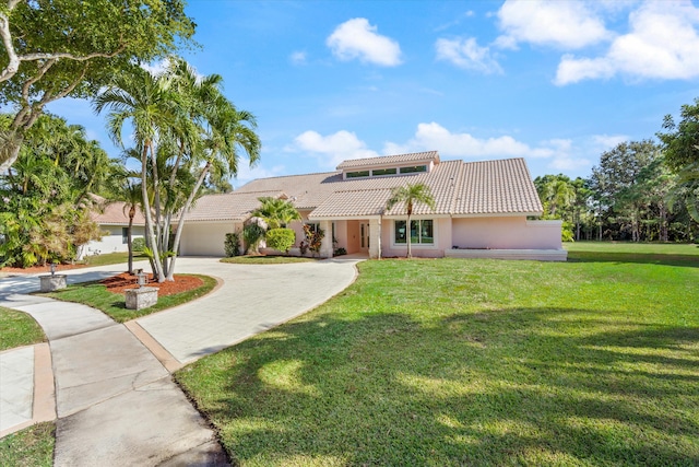 mediterranean / spanish-style home featuring a front yard