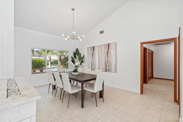 dining space with high vaulted ceiling and a chandelier