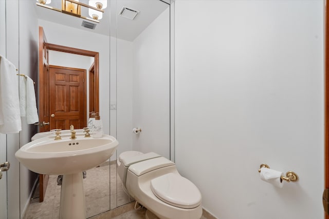 bathroom featuring tile patterned flooring and toilet