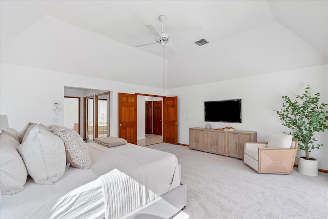 carpeted bedroom with ceiling fan, lofted ceiling, and ensuite bath