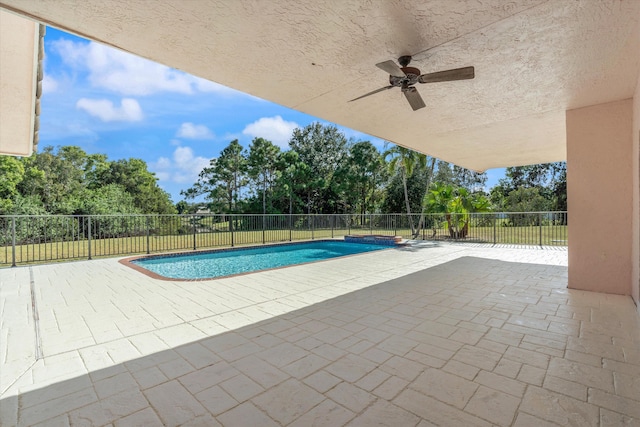 view of pool with ceiling fan and a patio area