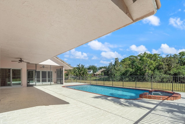 view of pool with a patio area, ceiling fan, and an in ground hot tub