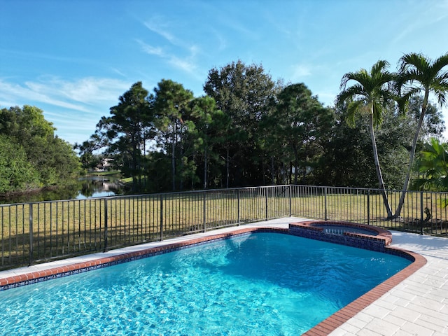 view of pool featuring an in ground hot tub and a water view