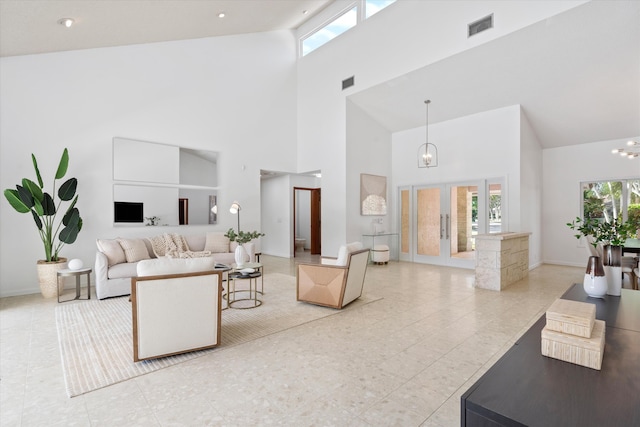 living room featuring french doors, light tile patterned floors, an inviting chandelier, and high vaulted ceiling