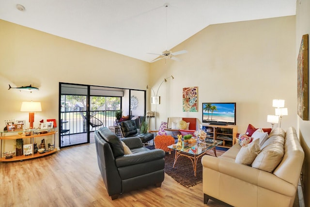 living room featuring ceiling fan, light wood-type flooring, and high vaulted ceiling