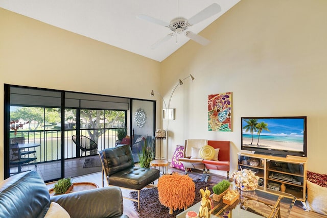 living room featuring ceiling fan, high vaulted ceiling, and wood-type flooring