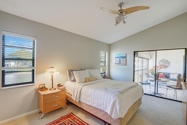 bedroom featuring access to outside, multiple windows, ceiling fan, and light carpet