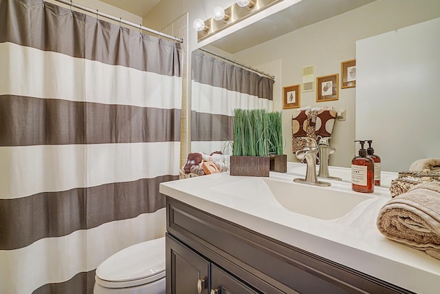 bathroom featuring vanity and toilet