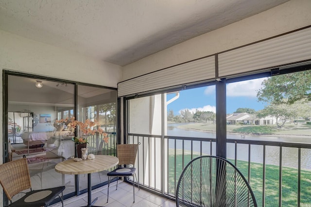 sunroom / solarium with a water view