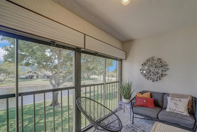 sunroom featuring plenty of natural light and a water view