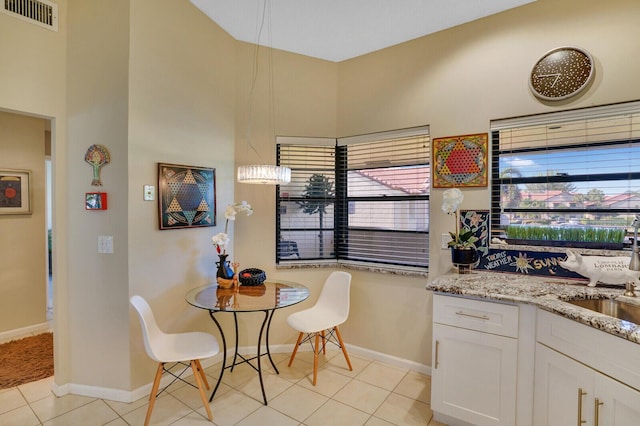 dining space with sink and light tile patterned floors