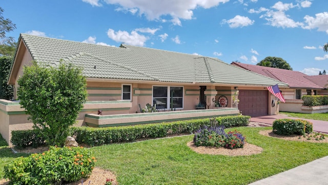 view of front of property with a front lawn and a garage