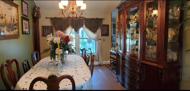 dining room featuring a notable chandelier and dark hardwood / wood-style flooring