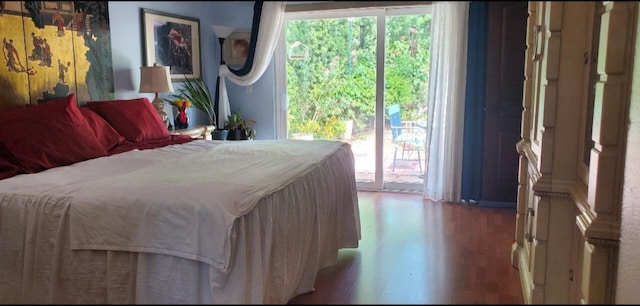 bedroom with access to outside and light hardwood / wood-style floors