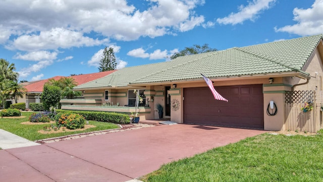 ranch-style home with a garage and a front yard