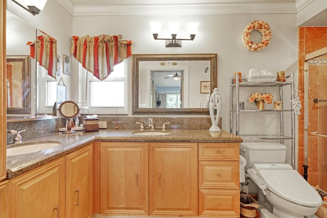 bathroom with vanity, toilet, and ornamental molding