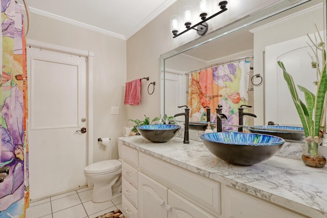 bathroom with tile patterned flooring, vanity, toilet, and crown molding