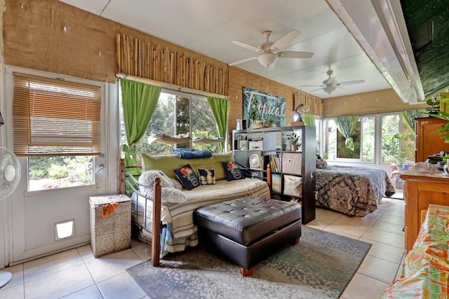 tiled bedroom featuring multiple windows and wood walls