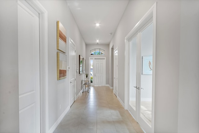 corridor featuring light tile patterned floors