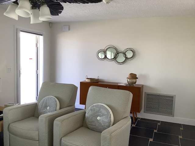 living area with a textured ceiling