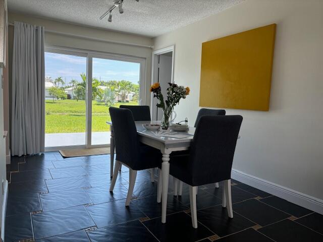 dining space with a textured ceiling