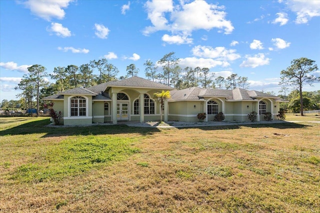 back of property featuring a lawn