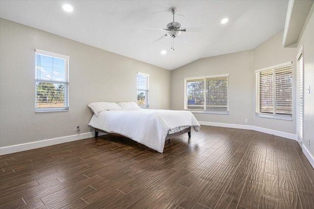 bedroom featuring multiple windows, dark hardwood / wood-style flooring, ceiling fan, and lofted ceiling