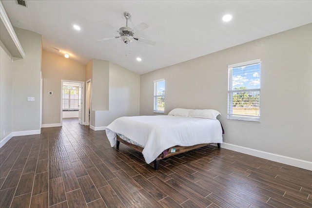 bedroom featuring ceiling fan, dark hardwood / wood-style flooring, and multiple windows