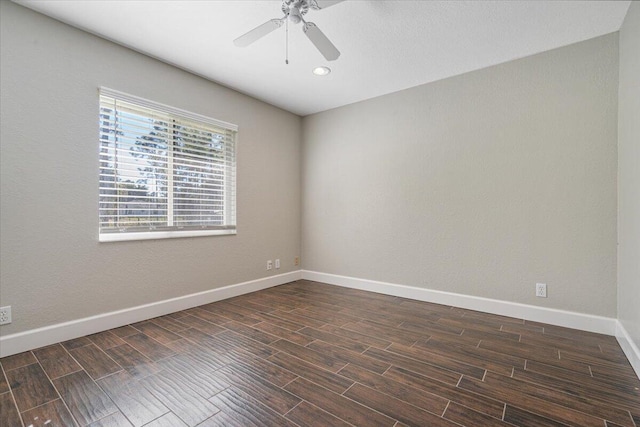 spare room with ceiling fan and dark hardwood / wood-style floors