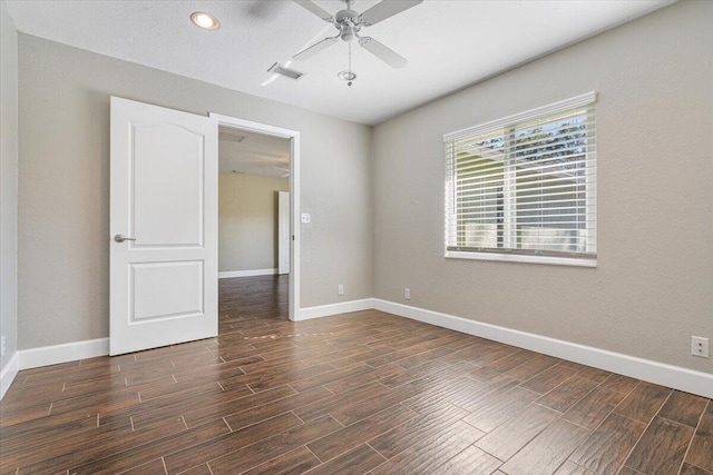 unfurnished room featuring dark hardwood / wood-style floors and ceiling fan