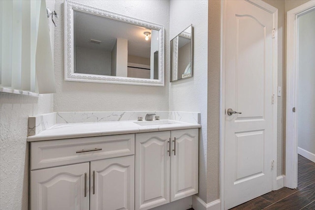 bathroom featuring hardwood / wood-style flooring and vanity