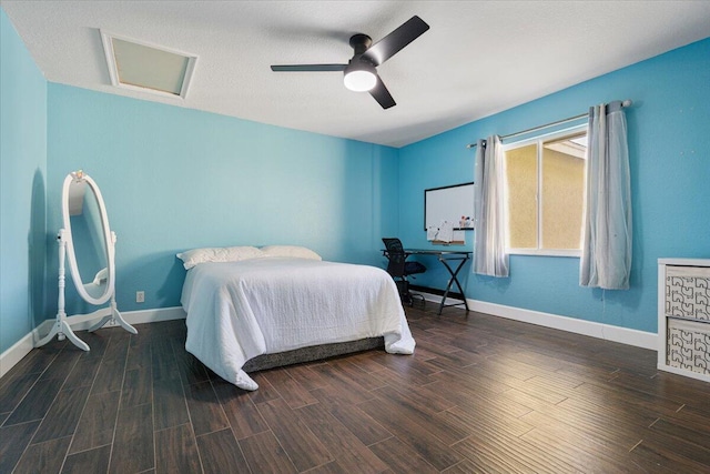 bedroom with a textured ceiling, dark hardwood / wood-style flooring, and ceiling fan