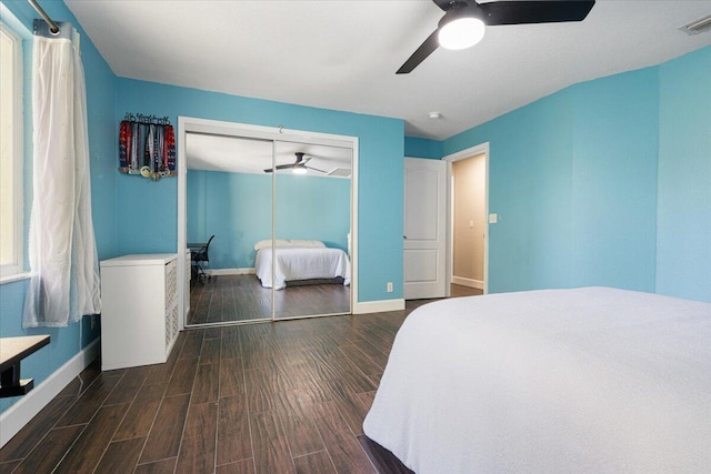 bedroom with a closet, ceiling fan, and dark wood-type flooring