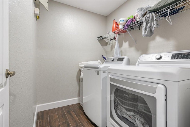 laundry area with washing machine and dryer and dark hardwood / wood-style floors