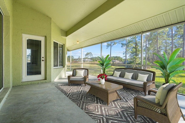 sunroom featuring lofted ceiling